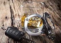 Glass of wine car key and handcuffs