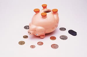 upside down piggy bank and coins